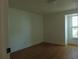 This bright bedroom offers wood-look flooring, neutral walls and trim, and a window for natural light at 16147 Sagebrush Rd, Tampa, FL 33618