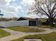 Charming home with a well-maintained front yard, white fence, and inviting blue door at 16147 Sagebrush Rd, Tampa, FL 33618