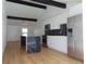 Kitchen features a large island with dark marble countertop, stainless steel appliances, and bright white cabinetry at 16147 Sagebrush Rd, Tampa, FL 33618