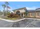 Clubhouse exterior with lush landscaping and American flag at 17106 Carrington Park Dr # 622, Tampa, FL 33647