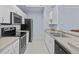 Kitchen featuring modern appliances, tile flooring, plenty of cabinet space, and modern countertops at 17106 Carrington Park Dr # 622, Tampa, FL 33647