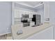 Kitchen with appliances, tile flooring, plenty of cabinet space, modern countertops, and ample lighting at 17106 Carrington Park Dr # 622, Tampa, FL 33647
