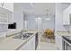Kitchen and dining area, featuring modern appliances, tile flooring, dining table with four chairs, and plenty of sunlight at 17106 Carrington Park Dr # 622, Tampa, FL 33647