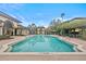 Inviting community pool with a sundeck, palm trees, and comfortable lounge chairs at 17106 Carrington Park Dr # 622, Tampa, FL 33647