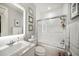 Bathroom featuring white tile, marble countertop sink, and shower with glass doors at 1755 Mccauley Rd, Clearwater, FL 33765