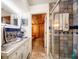 Bathroom with a steam shower, granite countertops and tile flooring with a view into the sauna at 1755 Mccauley Rd, Clearwater, FL 33765