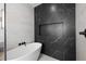 A modern bathroom features a sleek soaking tub and stylish black and white marble tiling at 211 W Columbus Dr # 1, Tampa, FL 33602