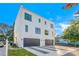 Modern three-story home featuring a two-car garage and a stylish driveway design at 211 W Columbus Dr # 1, Tampa, FL 33602