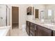 Bathroom featuring a double vanity, granite countertop, shower, and a separate soaking tub at 2208 Landside Dr, Valrico, FL 33594
