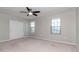 Carpeted bedroom with windows, ceiling fan, and closet at 2208 Landside Dr, Valrico, FL 33594