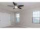 Bedroom with carpet, ceiling fan, closet, and two windows at 2208 Landside Dr, Valrico, FL 33594