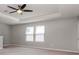 Well-lit bedroom with tray ceiling, large windows, and neutral paint at 2208 Landside Dr, Valrico, FL 33594