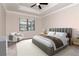 Comfortable bedroom featuring a ceiling fan, a large window, and a stylish upholstered bed frame at 2208 Landside Dr, Valrico, FL 33594