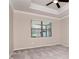 Bedroom with a ceiling fan, neutral walls, and natural light streaming through large windows at 2208 Landside Dr, Valrico, FL 33594