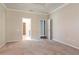 Large bedroom with neutral walls, carpet flooring, and an en suite bathroom at 2208 Landside Dr, Valrico, FL 33594