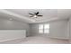 Bonus room with a ceiling fan, neutral carpet, and natural light streaming through large windows at 2208 Landside Dr, Valrico, FL 33594