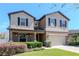 Charming two-story home with a well-manicured lawn and attached two car garage in a suburban neighborhood at 2208 Landside Dr, Valrico, FL 33594
