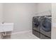 Laundry room featuring a modern washer and dryer and a utility sink at 2208 Landside Dr, Valrico, FL 33594