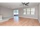 Open-concept living room with wood floors, ceiling fan, and access to screened patio at 2208 Landside Dr, Valrico, FL 33594