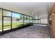 Spacious screened lanai with brick flooring, ceiling fans, and views of the fenced backyard at 2208 Landside Dr, Valrico, FL 33594