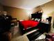 Bedroom with tile floor, dark furniture including dressers, and a red bedspread at 2213 65Th N Ave # 2213, St Petersburg, FL 33702
