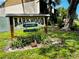 Community sign at Barkwood Square, with address below name and green landscaping at 2213 65Th N Ave # 2213, St Petersburg, FL 33702
