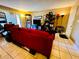 Bright living room featuring tile floors, and a comfortable red sofa at 2213 65Th N Ave # 2213, St Petersburg, FL 33702