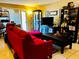 Comfortable living room with a stylish red sofa, dark furniture, and plenty of shelving for storage at 2213 65Th N Ave # 2213, St Petersburg, FL 33702