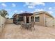 Well-maintained backyard with a brick patio, featuring a round table set under an umbrella, perfect for relaxing outdoors at 2240 Parrot Fish Dr, Holiday, FL 34691