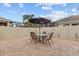 Private backyard with a brick-paved patio, a round table set under an umbrella, surrounded by a privacy fence at 2240 Parrot Fish Dr, Holiday, FL 34691