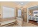 Bathroom boasts tiled shower, bench, and natural light from a large window at 2240 Parrot Fish Dr, Holiday, FL 34691