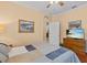 Bedroom with soft color palette, wood floors and dresser with mounted television at 2240 Parrot Fish Dr, Holiday, FL 34691