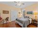 Bedroom with ceiling fan, wood floors and neutral color scheme at 2240 Parrot Fish Dr, Holiday, FL 34691