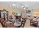 Dining area featuring a large wooden table, tile flooring, and view of the living room at 2240 Parrot Fish Dr, Holiday, FL 34691