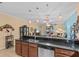 Open-concept kitchen with a breakfast bar, stainless steel appliances, and dark wood cabinetry at 2240 Parrot Fish Dr, Holiday, FL 34691