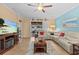 Bright living room with tile flooring, large sectional sofa, and access to the screened lanai at 2240 Parrot Fish Dr, Holiday, FL 34691