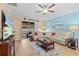 Inviting living room with tile flooring, large sectional sofa, and sliding glass doors to lanai at 2240 Parrot Fish Dr, Holiday, FL 34691