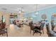 Bright and open living room with dining area, comfortable seating, tile flooring, and sliding door to lanai at 2240 Parrot Fish Dr, Holiday, FL 34691