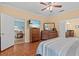 Well-lit main bedroom with wood floors and connecting doors to bathroom and other living areas at 2240 Parrot Fish Dr, Holiday, FL 34691