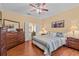 Spacious main bedroom with hardwood floors, dresser, and access to the main bathroom at 2240 Parrot Fish Dr, Holiday, FL 34691