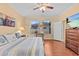 Sunny main bedroom with hardwood floors and a large window for natural light at 2240 Parrot Fish Dr, Holiday, FL 34691