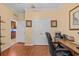 Office space with a dark wood desk and white closet doors at 2240 Parrot Fish Dr, Holiday, FL 34691