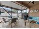 Screened patio with seating area and ceiling fan at 2240 Parrot Fish Dr, Holiday, FL 34691