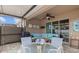 Inviting covered patio with comfortable seating, ceiling fan, and stylish decor for outdoor relaxation at 2240 Parrot Fish Dr, Holiday, FL 34691