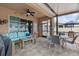 Charming covered patio featuring cozy seating, tiled floors, and sliding glass doors for seamless indoor-outdoor living at 2240 Parrot Fish Dr, Holiday, FL 34691