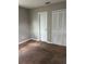 Bedroom showcasing beige carpet, gray walls, and a closet, providing ample storage space at 2484 Roberta St, Largo, FL 33771