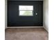Bedroom with dark molding on the wall and an off-white wall, beige carpet and white window at 2484 Roberta St, Largo, FL 33771
