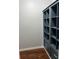 Walk-in closet with custom dark blue shelving and drawers with decorative white handles at 2484 Roberta St, Largo, FL 33771