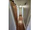 Hallway with hardwood floors features a rustic sliding barn door and access to multiple rooms at 2484 Roberta St, Largo, FL 33771