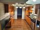Traditional kitchen layout with wooden cabinetry, updated countertops, and ample storage and counter space at 2484 Roberta St, Largo, FL 33771